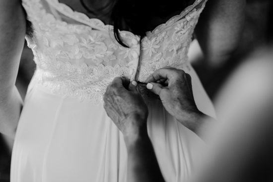 Buttoning up the wedding dress