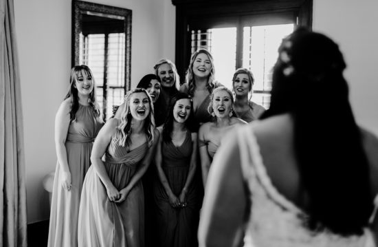 Bridesmaids are in awe of the bride