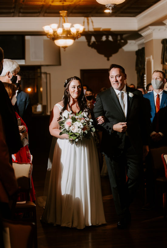 Bride walks down the aisle with her father at Loose Mansion wedding