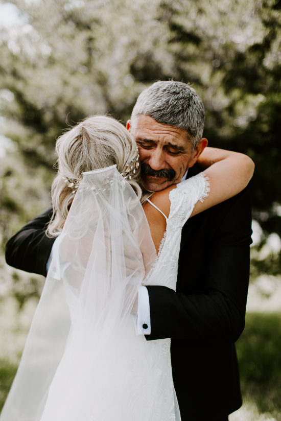 Dad hugs his daughter before her wedding