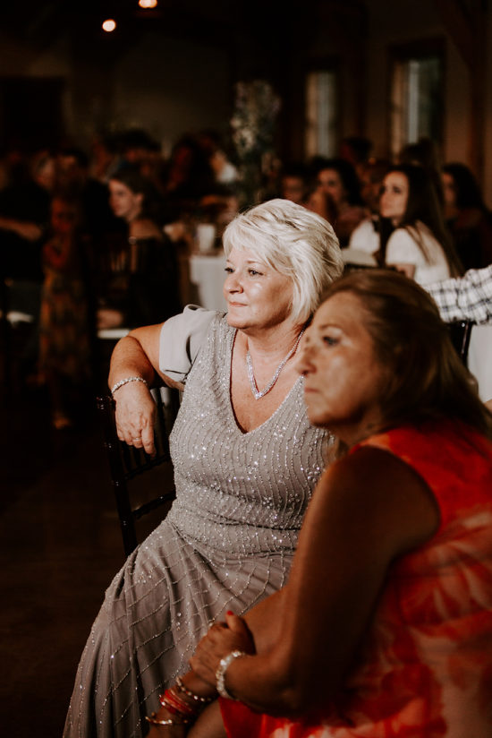 The bride's mother listens to the toast