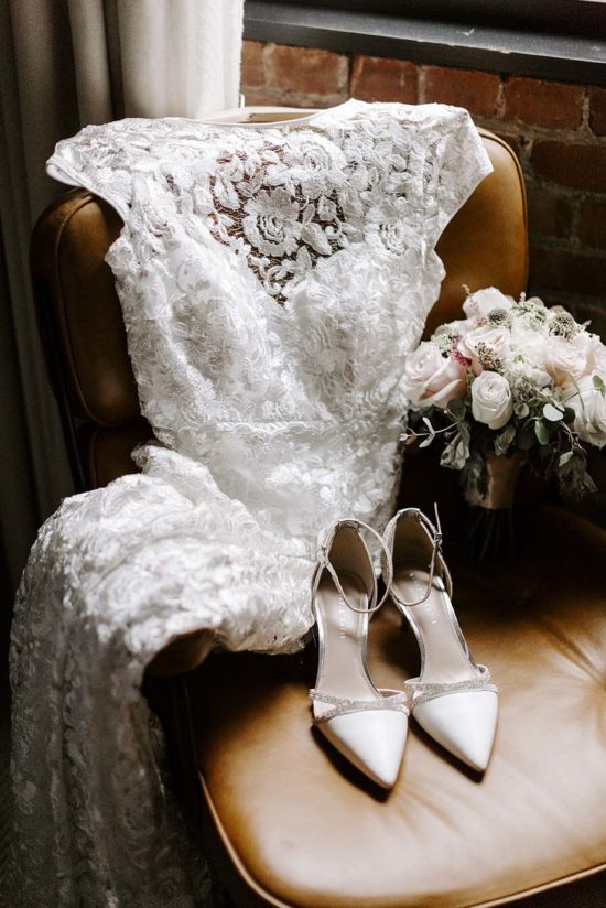 Detailed shot of wedding dress, shoes, and flowers