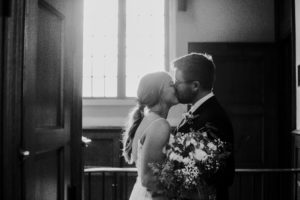 A bride and groom kiss on their wedding day
