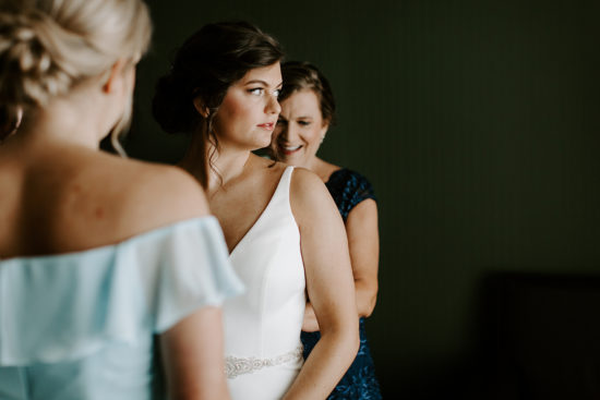 Bride getting ready with mom and sister