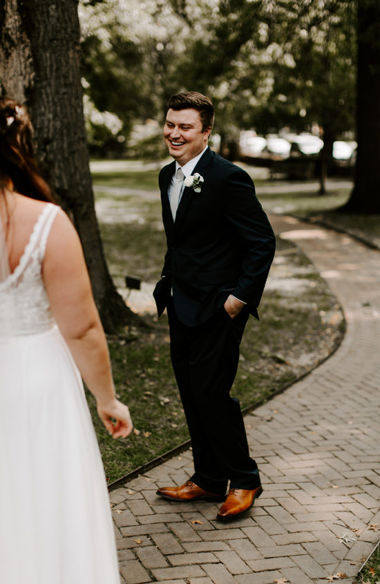 Groom smiles at his bride