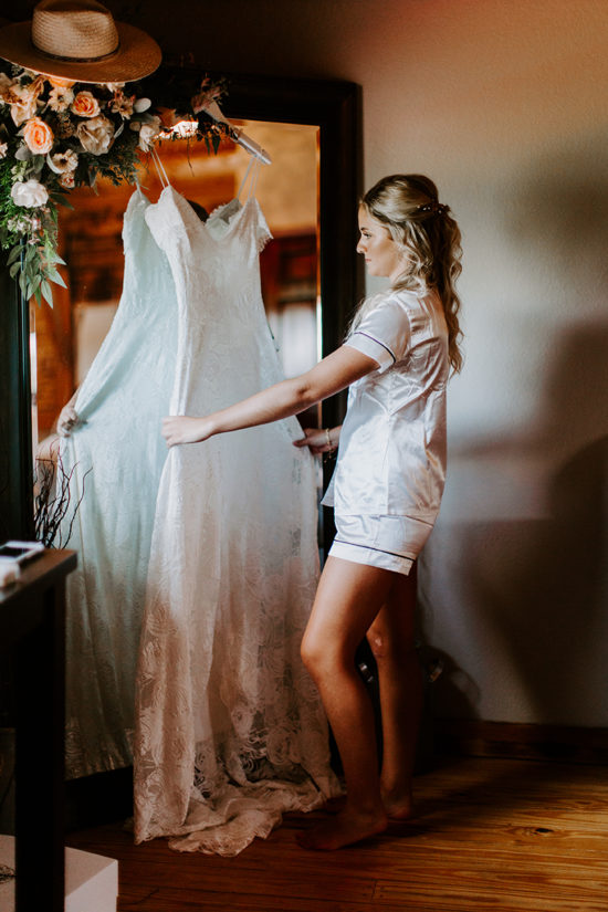 Bride looks at her dress