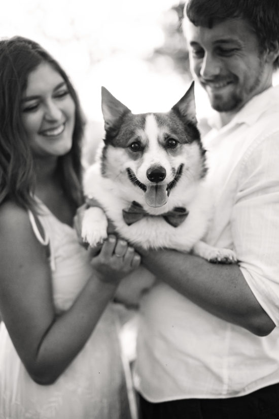 A couple holding their beloved dog 