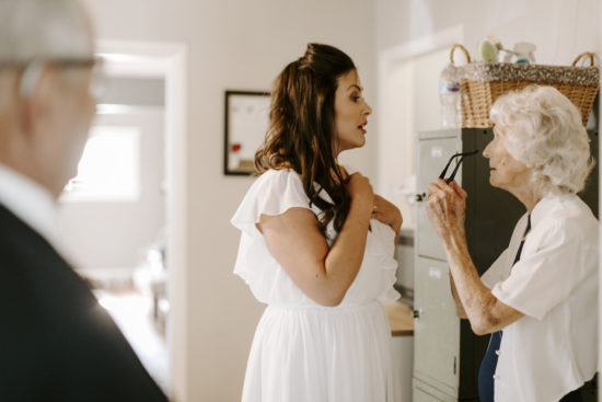 Bride stands talking to her grandmother