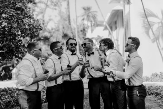 Groomsmen joke with the groom at a Mexico wedding