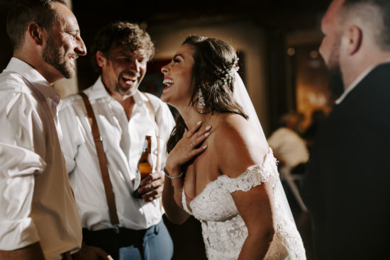Bride laughs while talking to her new husband