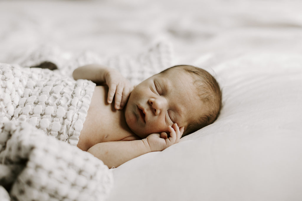 A baby boy sleeps during his newborn session.