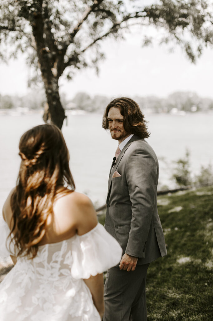 Trace turns to his bride and smiles after seeing her for the first time ahead of their Kansas lake house wedding.