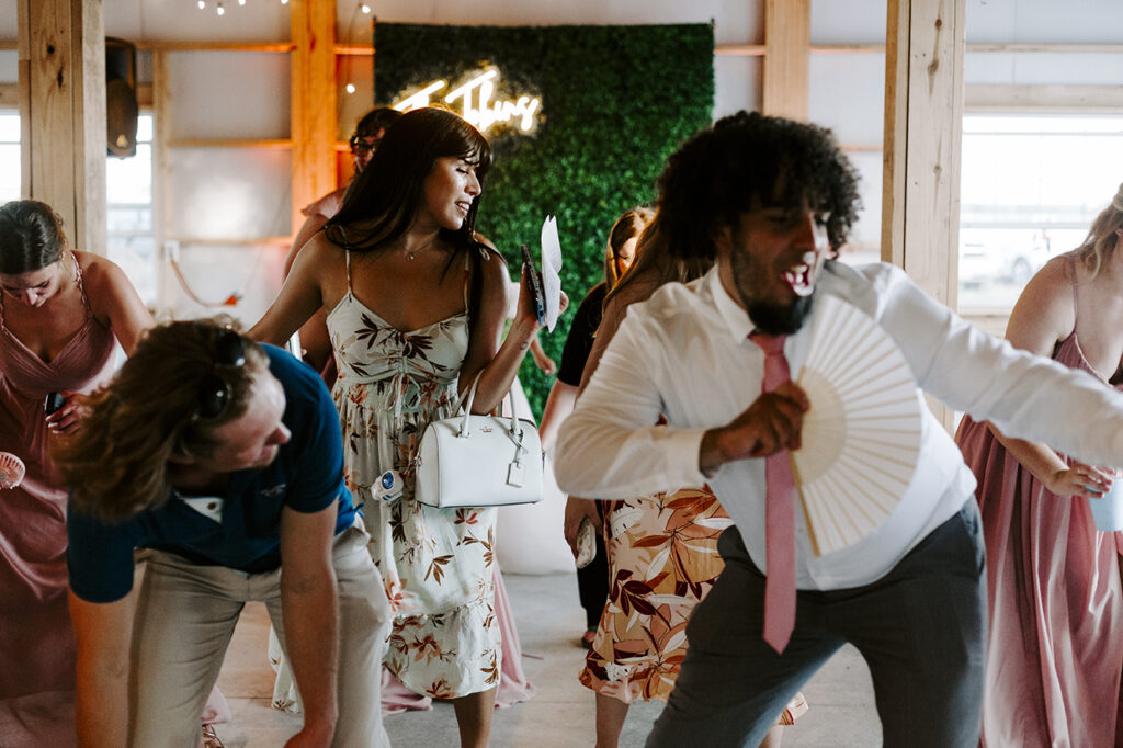 Guests dance and celebrate after the Tobins' Kansas lake house wedding.