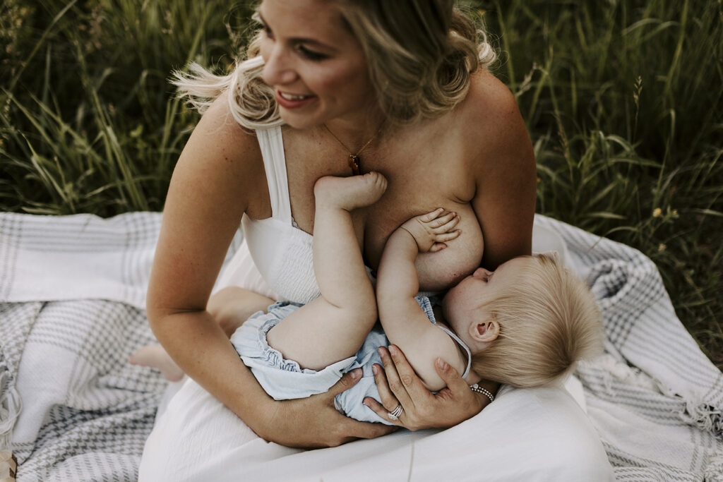 A woman enjoys quiet breastfeeding moments with her baby daughter.