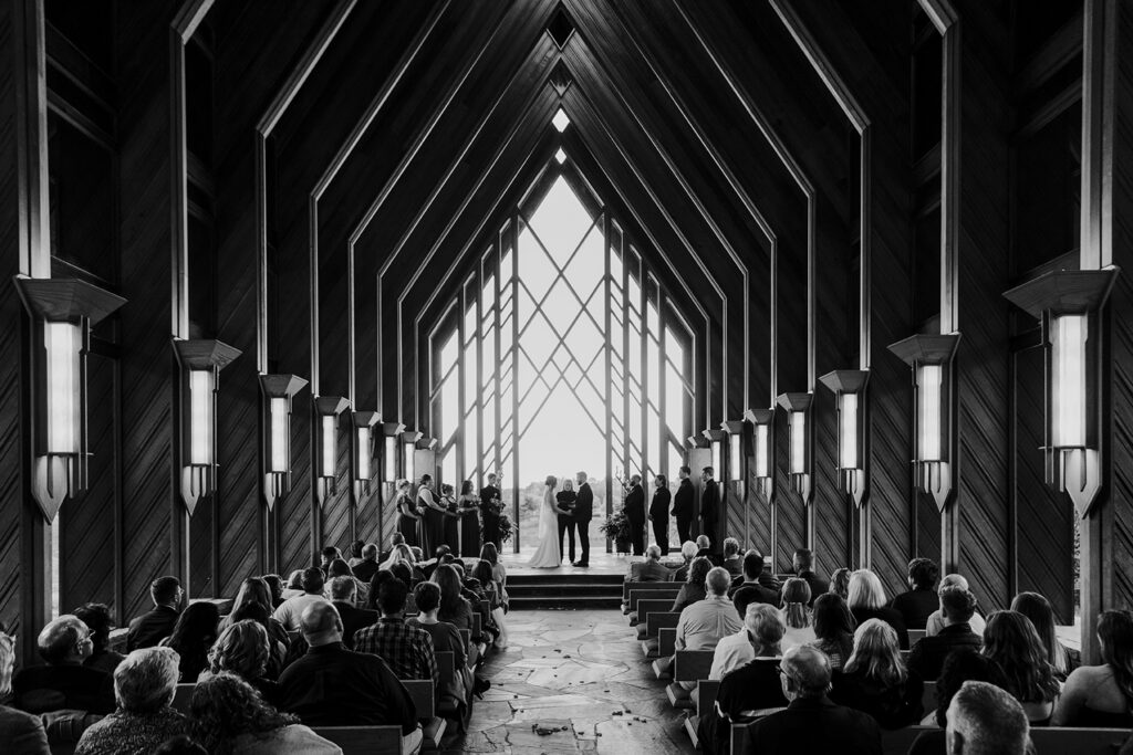 The couple say their vows at the front of the Marjorie Powell Allen Chapel during their Powell Gardens wedding.