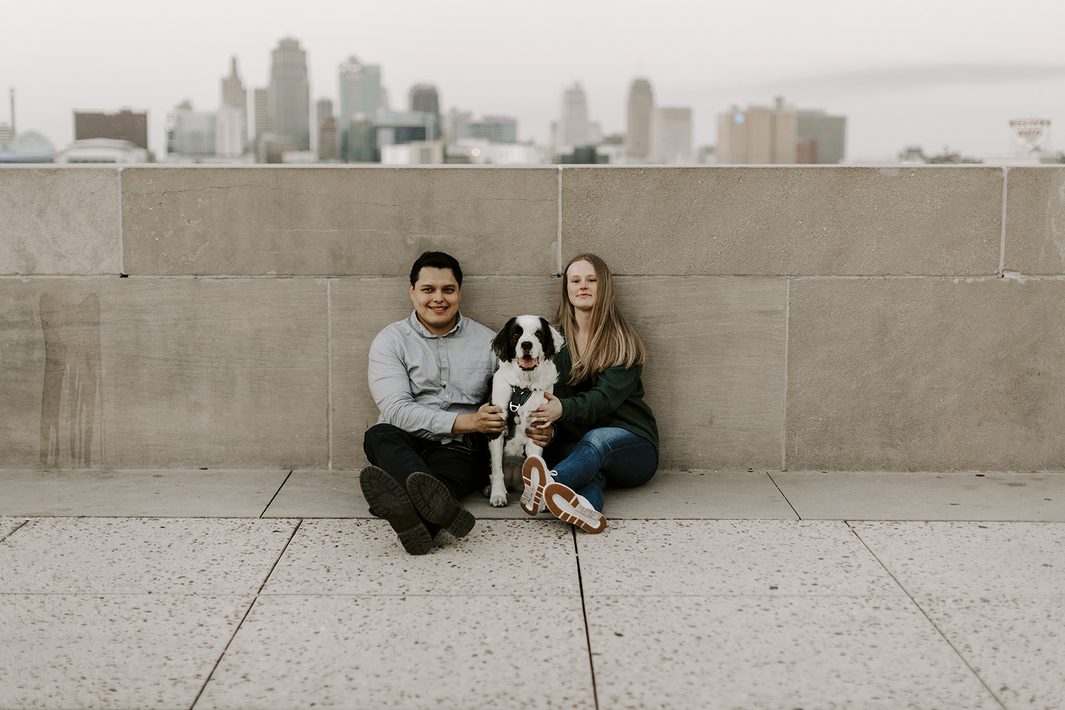 Carlos and Nicole pose with their dog at the World War One Museum for their Kansas City engagement photos
