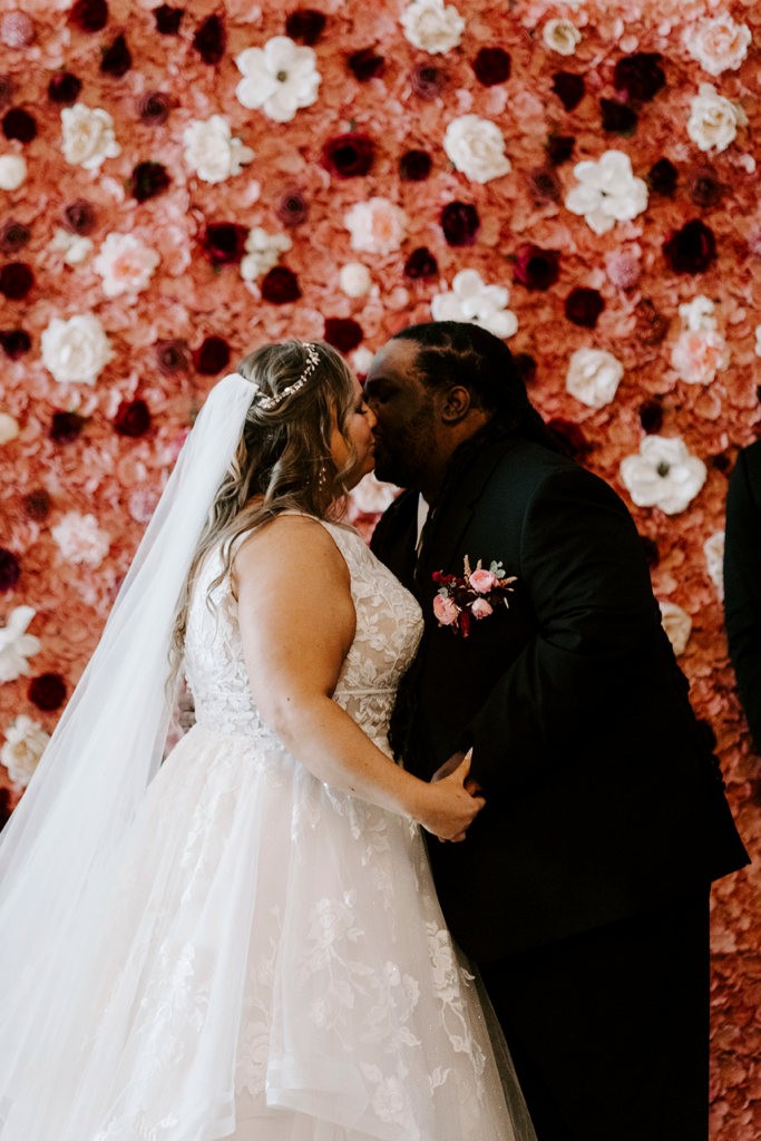 The bride and groom enjoy their first kiss at their North Lawrence wedding.